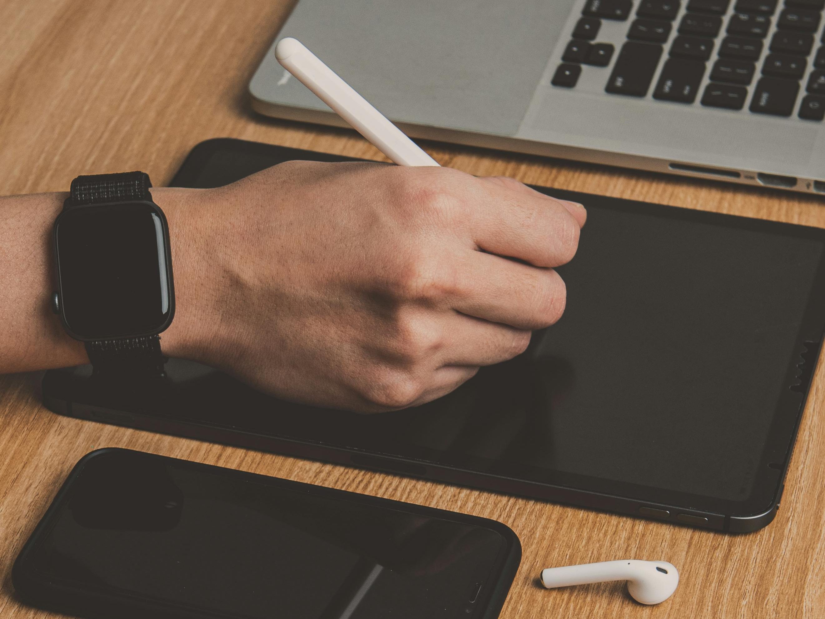 Graphic designer creating digital art and branding visuals on a drawing tablet for West Side Marketing